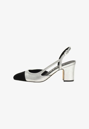 Silver slingback pump with a black cap toe, textured upper, and a block heel. Features cut-out sides and an adjustable strap for fit.
