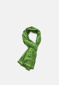 Green scarf made of soft fabric, featuring a floral pattern, smooth texture, and fringed edges. Wrapped in a loose, layered fashion.