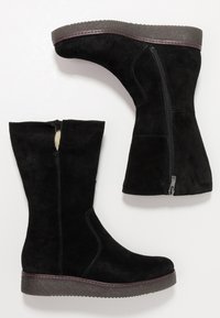 Black suede ankle boots with a mid-calf height, side zipper, and textured grey sole. Features a slight heel and stitching details.