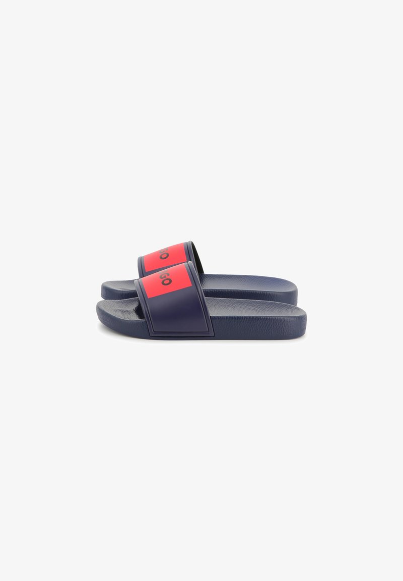 Navy blue sandals with red accents, rubber material, open design, textured footbed, and prominent logo on straps.