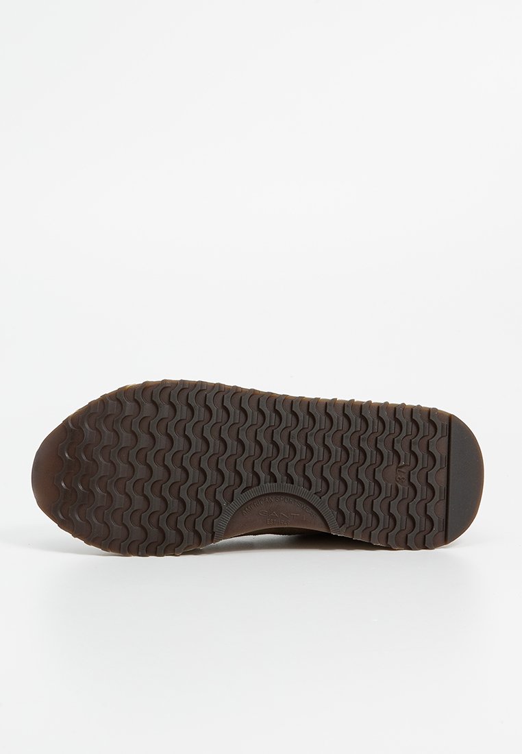 Bruine rubberen schoenzool met een getextureerd visgraatpatroon, een ronde neus en een geperst merklogo. Bevat gladde randen en een stevige constructie.