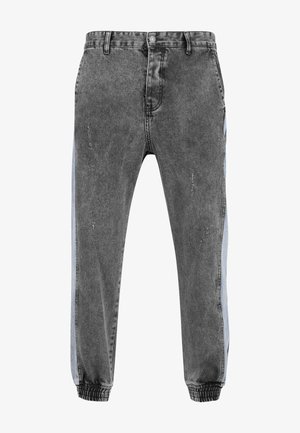 Denim joggers vaaleissa mustissa, joissa on vaaleansiniset sivuraidat. Ominaisuuksiin kuuluu normaali vyötärö, joustavat hihnat ja kulutetut yksityiskohdat.