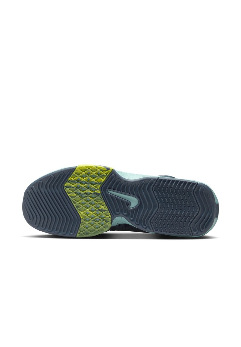 Die Sneaker-Sohle besteht aus strukturiertem Gummi in Dunkelblau mit einem gelb-grünen Akzent. Sie verfügt über eine gemusterte Grip-Oberfläche mit einem auffälligen Design und Logodetails.