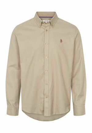 Béžová košeľa na gombíky s dlhým rukávom a špicatým golierom, dvoma gombíkmi na hrudi a malou vyšitou logom na ľavej strane. Mäkká textúra.