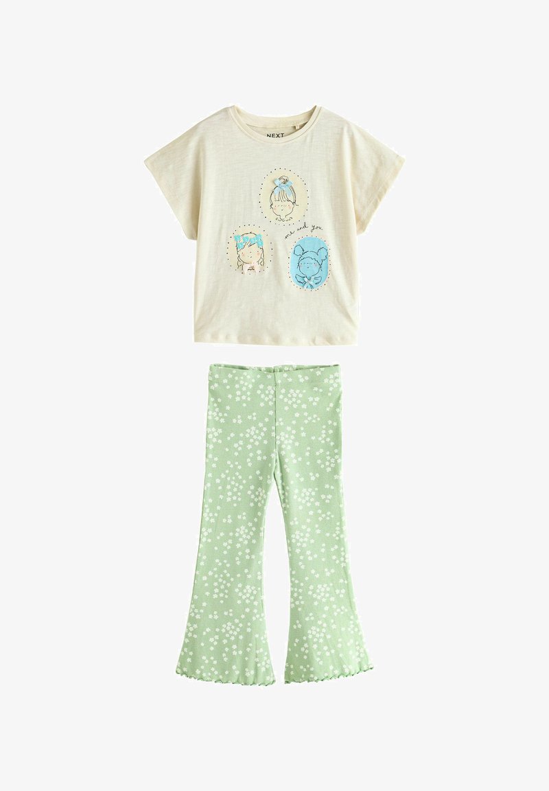 Cream short-sleeve top with three girl faces illustrations and mint green flared pants with white floral print for children.