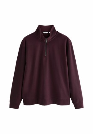 Burgundowy sweter z półzamkiem, wykonany z miękkiego materiału; ma długie rękawy i ściągacze przy mankietach.