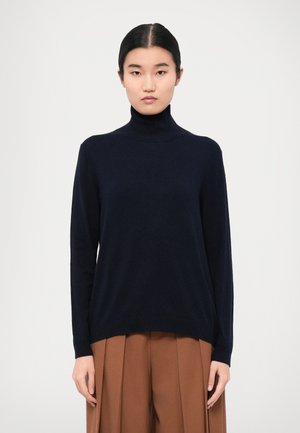 Navy turtleneck sweater made of soft fabric, featuring a relaxed fit and long sleeves. Smooth texture with a ribbed neckline and hem.
