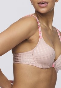 Light pink checkered bra with floral accents on the straps, featuring a smooth texture and a structured shape.