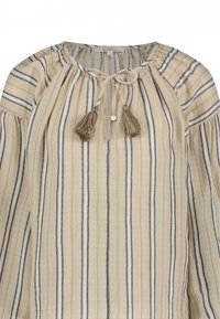 Beige en marineblauwe gestreepte blouse met een striksluiting en kwastjes, voorzien van een ronde halslijn en losse lange mouwen gemaakt van een gestructureerde stof.