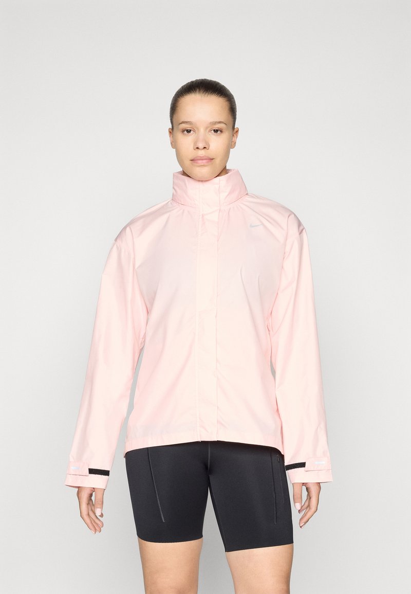 Light pink waterproof jacket with a high collar and long sleeves. Features black accents on cuffs and a small logo on the upper left.