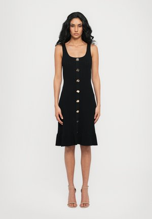 Black knitted dress with a square neckline, gold button details, and a flared hem. Features a fitted design and knee-length cut.
