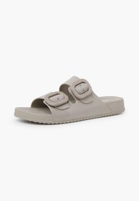Sandalo scivoloso beige realizzato in plastica liscia, con due fibbie regolabili, design open toe e suola testurizzata per una migliore aderenza.