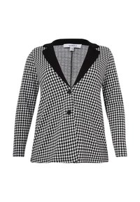 Sort og hvidt houndstooth-mønsteret blazer med sort revers, lange ærmer og to frontlommer. Har knaplukning.