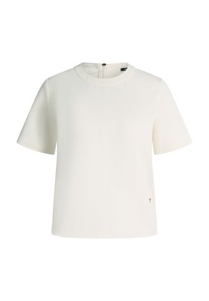 Witte blouse met korte mouwen, ronde halslijn, ritssluiting aan de achterkant en een klein metalen label bij de zoom aan de rechterkant.