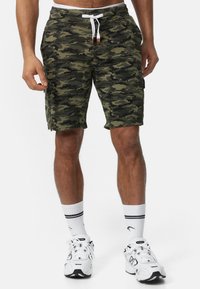 Camo shorts in groentinten, gemaakt van zachte stof. Kenmerkt een elastische tailleband met trekkoord, zijzakken en een knielange snit.