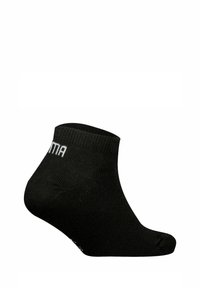 Schwarze Knöchelsocke aus gestricktem Stoff, mit einem gerippten Bündchen und dem Wort "ANIMA" in Weiß an der Seite. Kompakte und schlichte Gestaltung.