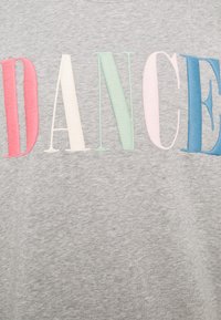 Gray cotton t-shirt featuring the word "DANCE" in multicolored embroidered letters: red, white, green, pink, and blue. Smooth texture.