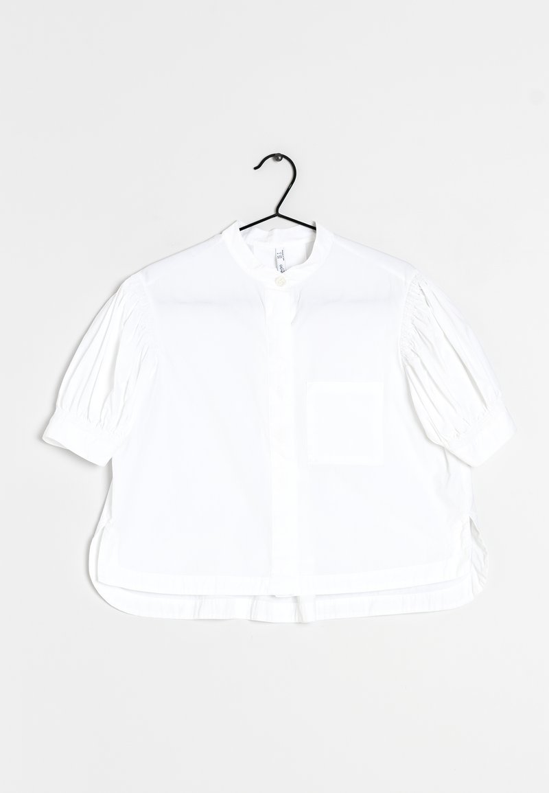 White short-sleeve blouse with a round collar, front button closure, and a chest pocket. Features gathered detailing on sleeves.