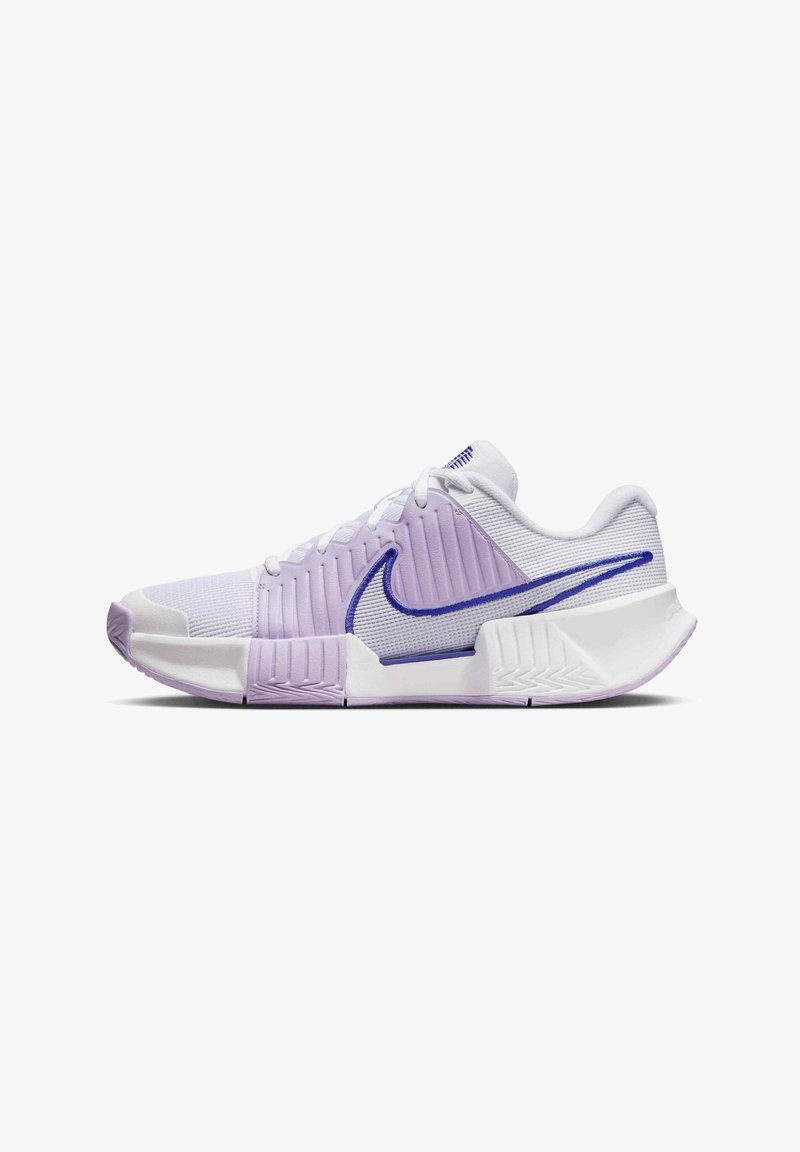 White athletic shoe with purple accents, textured upper, and a cushioned sole. Features a distinctive Nike swoosh logo on the side.