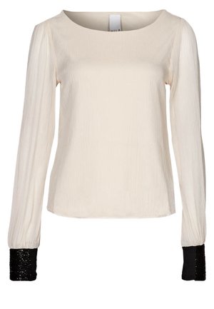 Long-sleeve cream blouse with textured fabric and contrasting black sequin cuffs, featuring a round neckline and a relaxed fit.