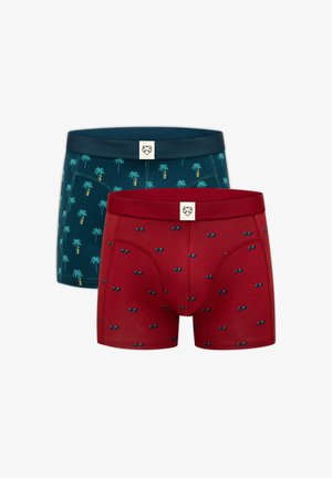 Zwei Paar Boxershorts, ein rotes mit kleinen Sonnenbrillenmustern, ein dunkelgrünes mit Palmenmustern, beide mit einfarbigen Bund.