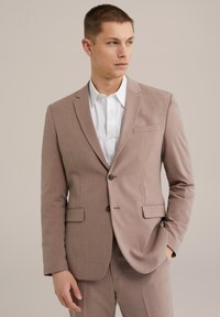 Világosbarna szabott zakó, amelynek kihajtott gallérja, két elülső zsebe, egysoros gombolása és enyhén texturált anyaga van.