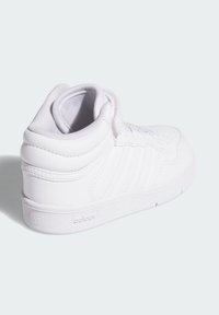 Bílé tenisky s vysokým střihem vyrobené z kůže, s texturovanou gumovou podrážkou, perforovanými detaily a třemi diagonálními pruhy na bočním panelu.