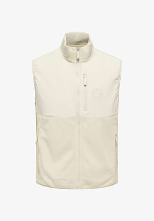 Veste sans manches en polaire beige avec col montant, fermeture éclair à l'avant, poche poitrine zippée et logo subtil sur le côté gauche de la poitrine.