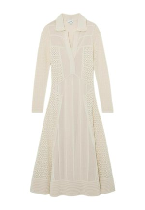 Pikk kreemjas kudumkleit pikkade varrukatega, kraega V-kaelusega, tekstuurse siksak- ja vertikaalsete mustritega ning lehviva servaga.