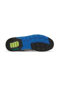 Suola di scarpa con un design a più strati caratterizzato da gomma nera, sezioni blu e un inserto in schiuma verde. Logo "Reebok" in teal.