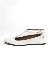 Ballet flat bianco con punta arrotondata e design a T-strap. Realizzato in materiale liscio con texture a righe e piccolo accento metallico.