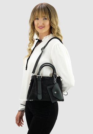 Schwarze Handtasche mit doppelten Griffen und abnehmbarem Gurt. Hergestellt aus glattem Leder, verfügt sie über eine Fronttasche mit Druckknopfverschluss und silbernen Akzenten.