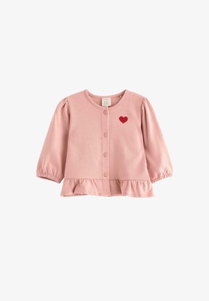 Ljusrosa långärmad topp med rundad halsringning, framknappar, elastiska ärmavslut, volangnederdel och ett rött hjärta broderat på bröstet.