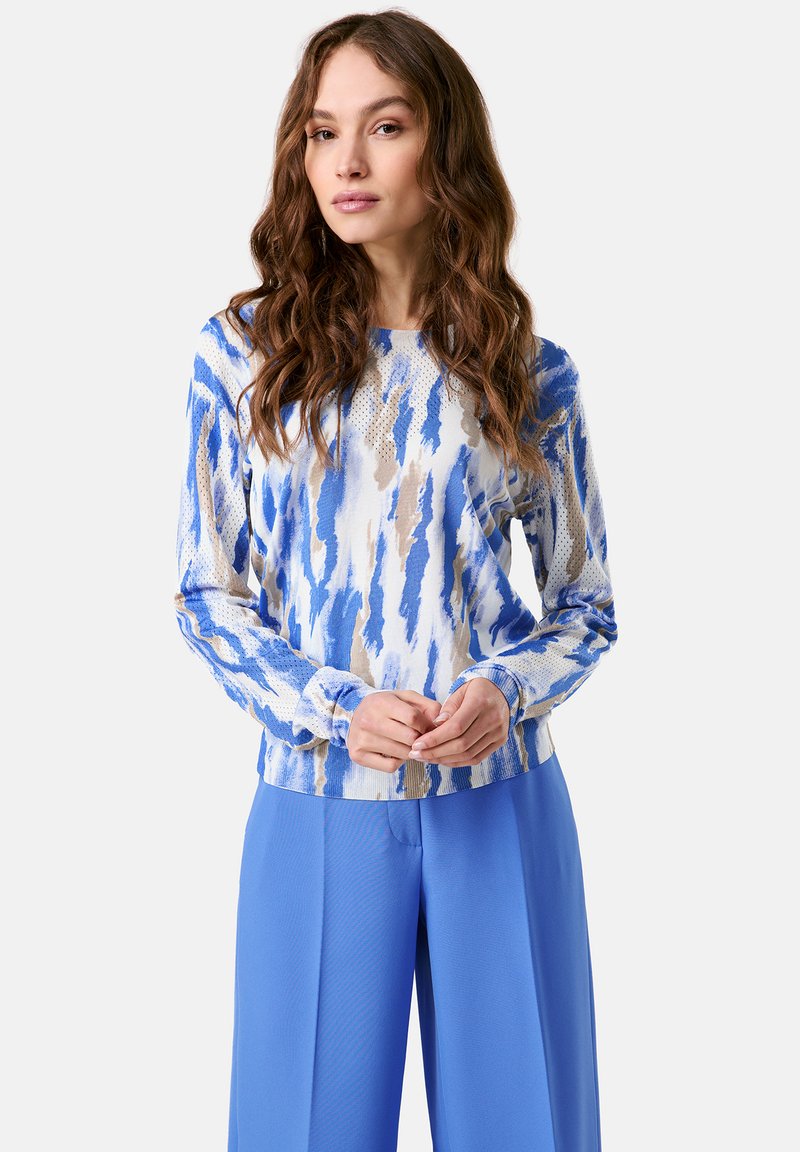 Langärmliges Oberteil in blau, weiß und braunem abstraktem Muster. Hergestellt aus strukturiertem Stoff mit rundem Ausschnitt und schmalen Bündchen.
