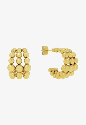 Złote kolczyki w kształcie obręczy z warstwowym wzorem kulistych koralików, gładką fakturą i zapięciem na sztyft.