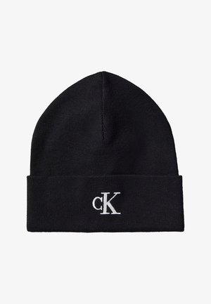 Bonnet tricoté noir avec revers plié et logo blanc "cK" brodé au centre avant du revers.