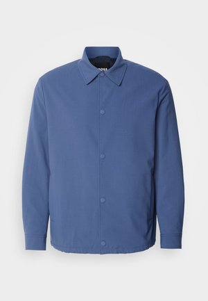 Light blue button-up jacket with a collar, long sleeves, and front pockets. Made from smooth, durable fabric with minimalistic design.