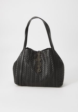 Black quilted handbag in a rounded shape, featuring a textured weave pattern, dual handles, and a prominent golden logo accent.