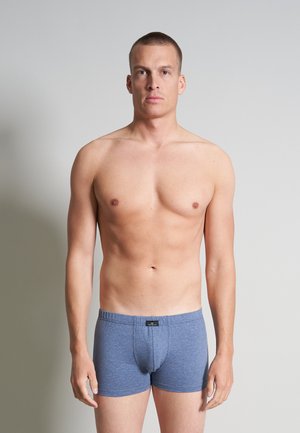 Boxers en coton bleu avec une ceinture élastique confortable, offrant un ajustement snug. Le tissu a une apparence lisse et texturée.