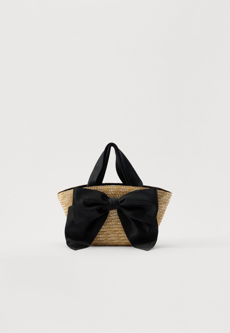 Viimistletud heinakotil on must siidist pael. Kotil on kaks kangast käepidet ja avatud ülaosa. Tekstureeritud looduslik materjal.