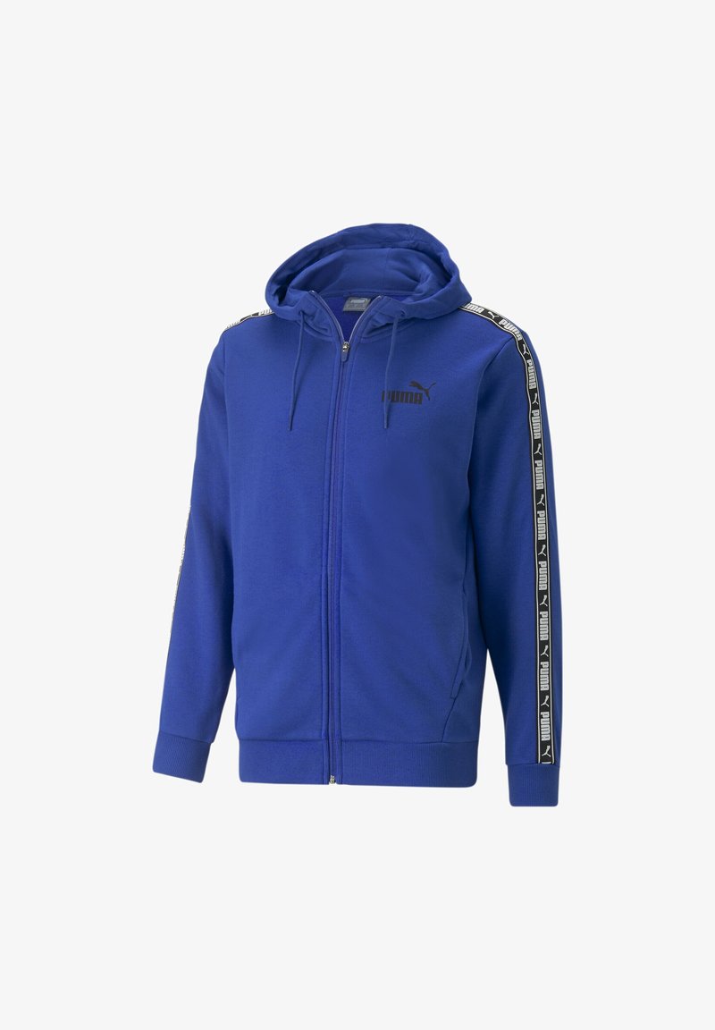 Sweat à capuche zippé bleu avec logo Puma noir sur la poitrine et bandes noires et blanches de marque courant le long des manches, doté d'une capuche avec cordon de serrage.