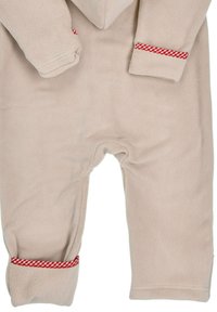 Beige fleece onesie with long sleeves, featuring red gingham accents at the cuffs. Soft texture, full-length legs, and no visible fastenings.