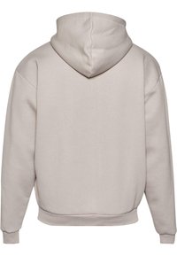 Lys beige hettegenser med hette, laget av myk bomullsblanding. Har ribbede mansjetter og nederkant, glatt tekstur og en avslappet passform.