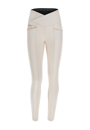 Vaaleanbeige korkeavyötäröiset legginsit, joissa on risteävä vyötärönauha, kaksi sivutaskua, slim fit -leikkaus ja kontrastiväritikkaukset.