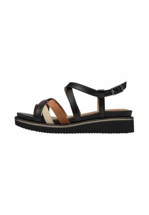 Sandali in pelle nera con fasce incrociate in tan e beige, suola a zeppa bassa e cinturino alla caviglia regolabile, fondo con texture.