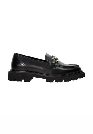 Black leather loafer with a flat, textured sole and a decorative metal buckle accent. Features rounded toe and classic stitching details.