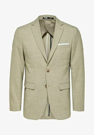Lichtbeige blazer van een gestructureerde stof, met twee voorzakken, twee knopen en een witte pochette. Slim fit ontwerp met contrasterende voering.