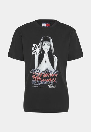 Mustan puuvillateepaidan etupuolella on graafinen printti, jossa on nainen kädet ristissä ja tekstit "Britney Spears" värikkäällä tyylitellyllä fontilla.