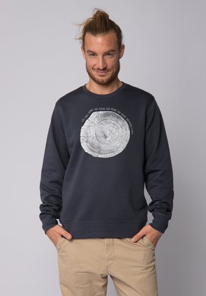 Donkerblauwe sweatshirt van katoen, voorzien van een zilveren boomringgrafiek en omringende tekst. Geribbelde ronde halslijn en manchetten.