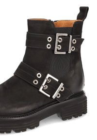 Black leather ankle boot with two adjustable straps, silver hardware, elastic side panels, and a chunky rubber sole for traction.